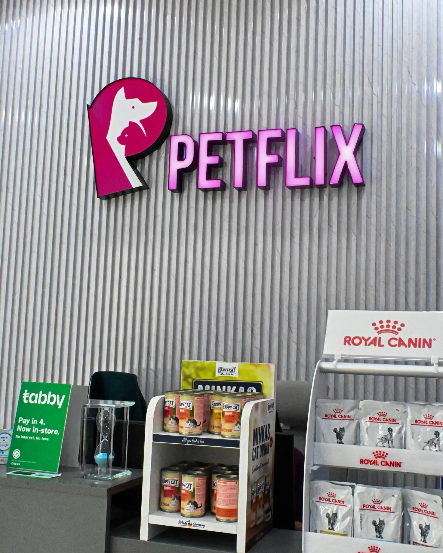 The veterinary diet display under the Petflix neon sign at reception, where over-the-counter items are sold